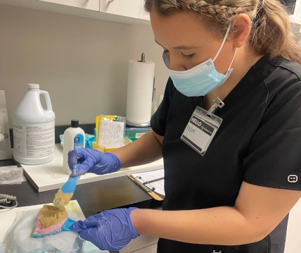 Dental Assistant School student training with dental impressions