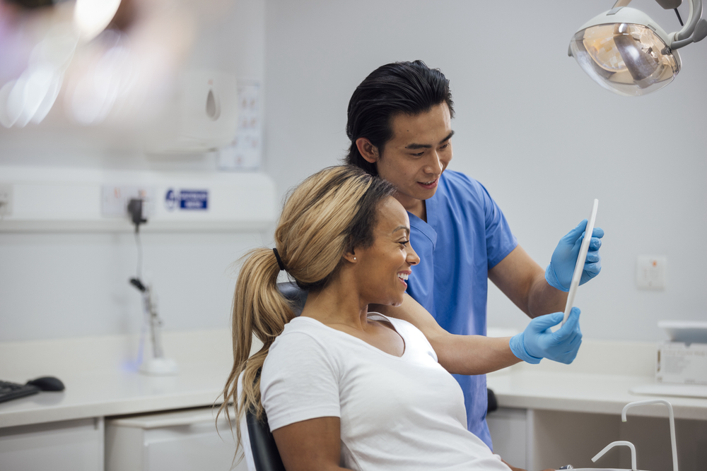 Dental assistant reviewing digital radiographs