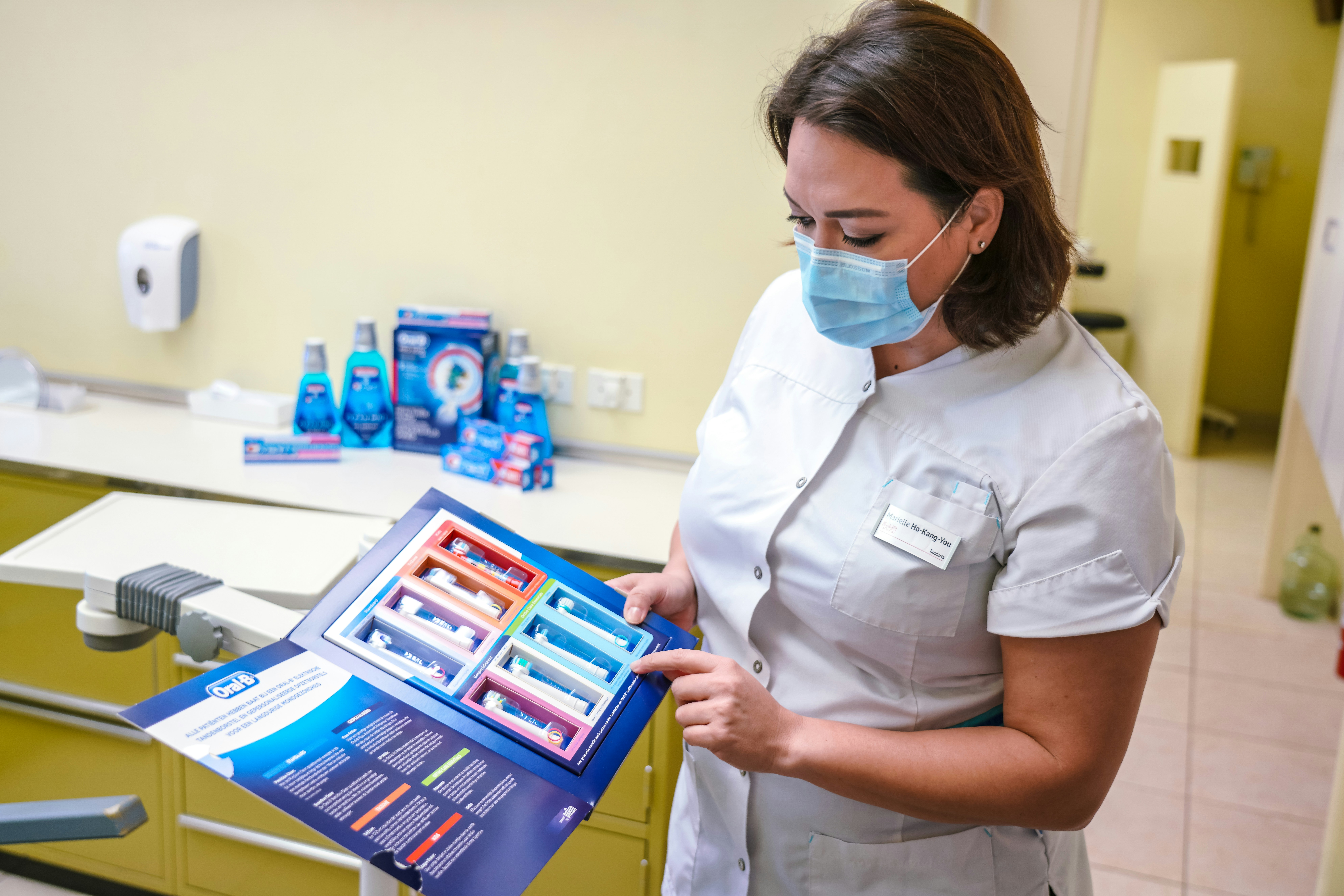 dental assistant displaying toothbrush products